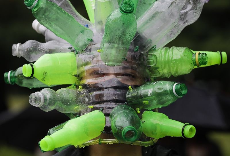 A protester wears a face shield made of recycled plastic bottles by artist Leeroy New during a anti-terror bill rally at the University of the Philippines as they observe Independence Day on Friday, June 12, 2020, in Metro Manila, Philippines. Hundreds of activists in the Philippine capital staged protests Friday against a proposed anti-terror law they say could be used to quash dissent, ignoring police threats that they could be arrested for violating coronavirus restrictions against large public gatherings. (Photo by Aaron Favila/AP Photo)
